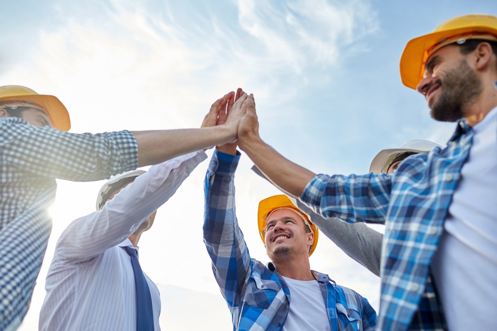 Builders wearing safety hats