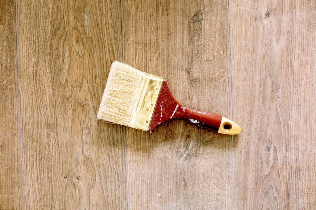 paintbrush on wooden floor