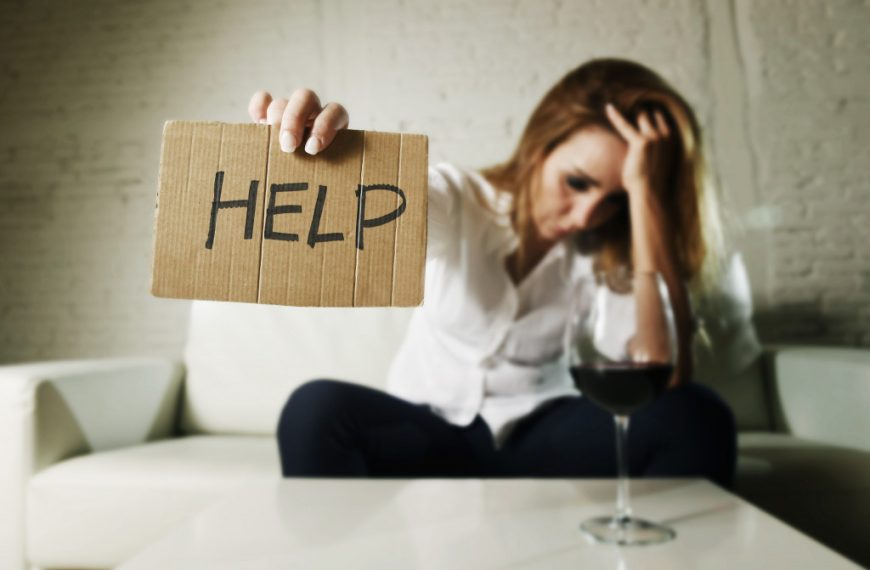 a woman holding a cardboard sign that says help