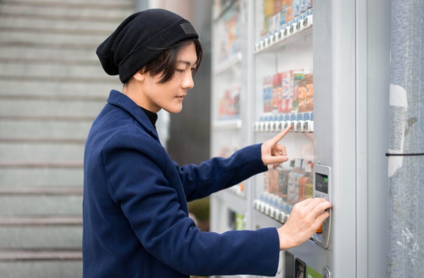 man buying from a cashless vending machine