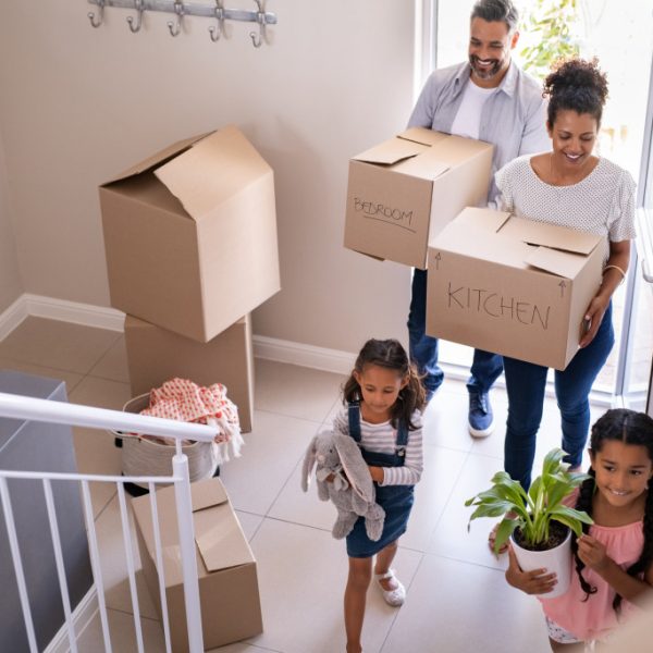 family moving into their new home with boxes